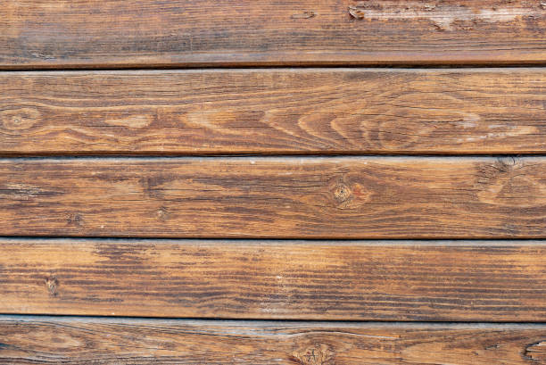 istock Brown wood texture background coming from natural tree. The wooden panel has a beautiful dark pattern, hardwood floor texture 1390995530