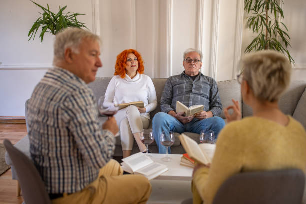 istock Senior people having fun during book reading meeting 1390995941