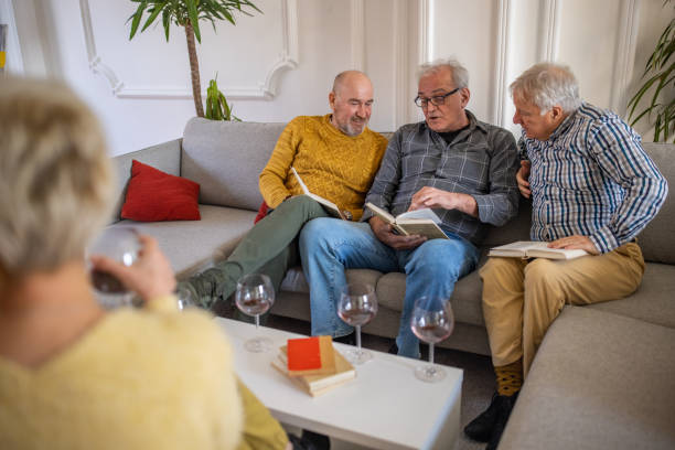 istock Senior people having fun during book reading meeting 1390996109