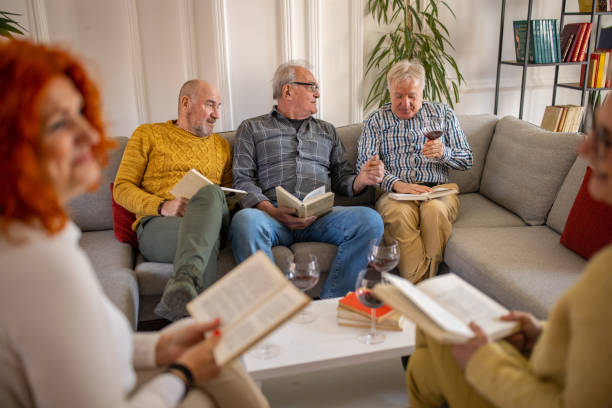istock Senior people having fun during book reading meeting 1390996895