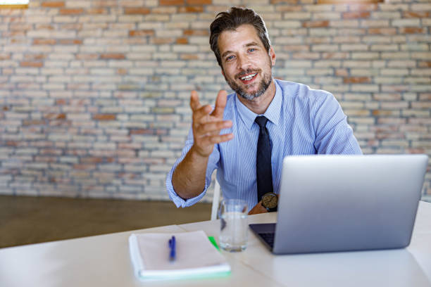 istock Happy male entrepreneur talking during conference call. 1390997038
