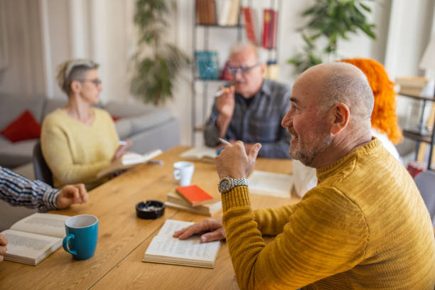 istock Senior people reading and discuss the reference book, during book reading meeting 1390997338
