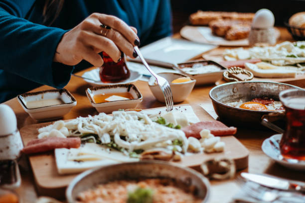 istock Turkish Breakfast,  Sunday big breakfast or brunch with white cheese and egg, Turkish spread breakfast served in the restaurant, woman having breakfast, woman eating 1390998500