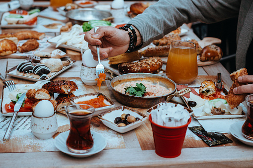 Turkish Breakfast, Sunday big breakfast or brunch with feta cheese and eggs, Turkish breakfast served in restaurant, man and woman having breakfast, man and woman eating, menemen for breakfast