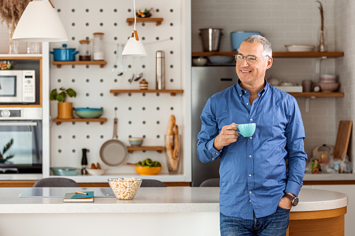 Cropped shot of a handsome mature man enjoying a cup of coffee in the morning