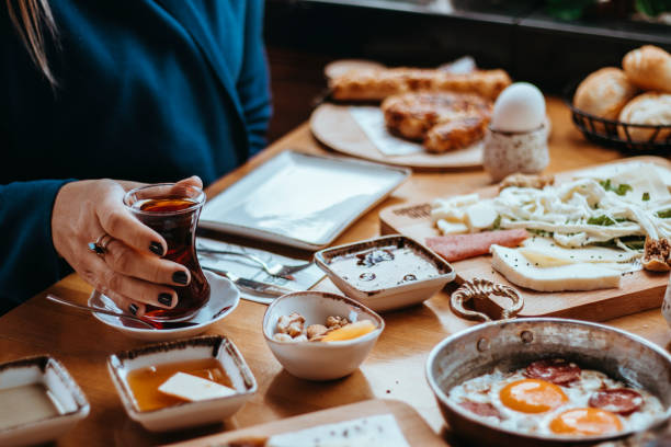 istock Turkish Breakfast,  Sunday big breakfast or brunch with white cheese and egg, Turkish spread breakfast served in the restaurant, woman having breakfast, woman eating 1390999742