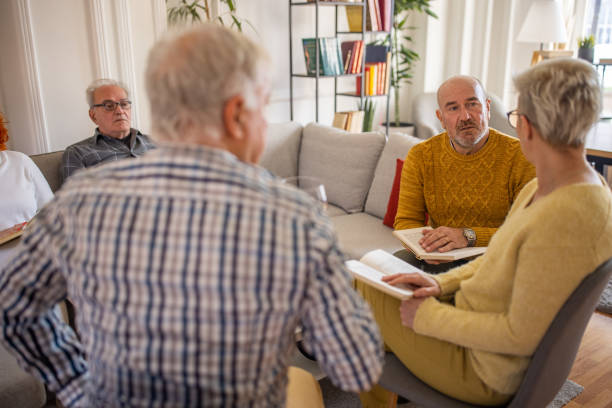 istock Senior people having fun during book reading meeting 1390999993