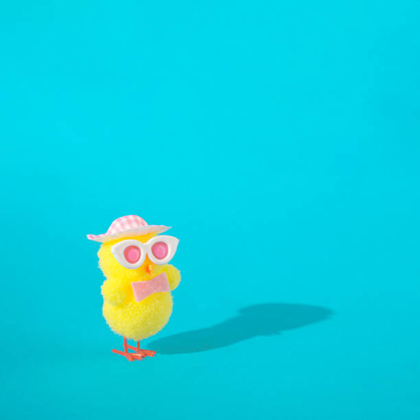 istock Modern yellow Easter chicken with sun glasses and pink hat. Spring summer sunny concept idea. 1391001735