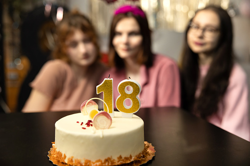 Friends presenting birthday cake to girl. Happy birthday to you.