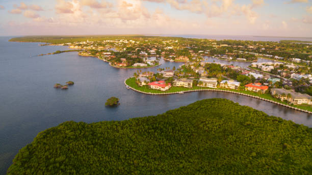 Key Largo island Aerial view of homes on waterfront in Key Largo during sunrise, Florida, USA. key largo stock pictures, royalty-free photos & images
