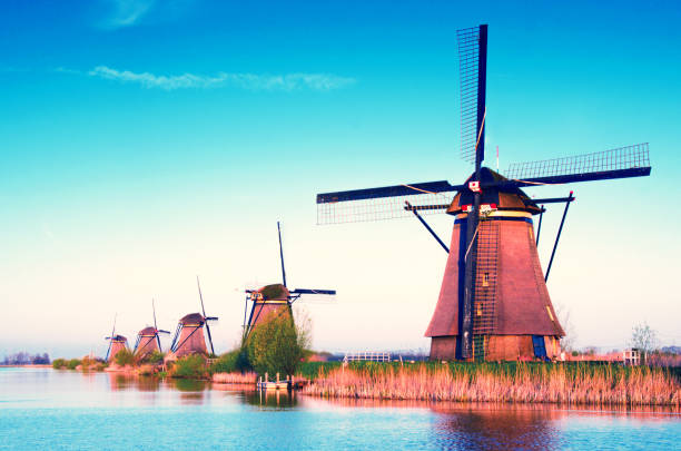 istock breathtaking beautiful inspirational landscape with windmills in Kinderdijk, Netherlands. Fascinating places, tourist attraction. 1391005459