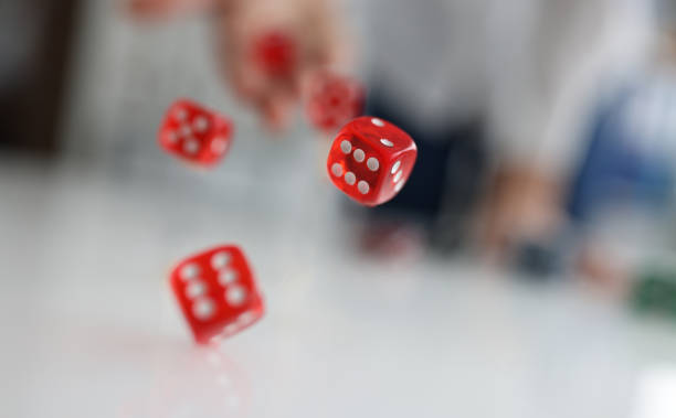 istock Woman hand throws red dice into air closeup 1391008327