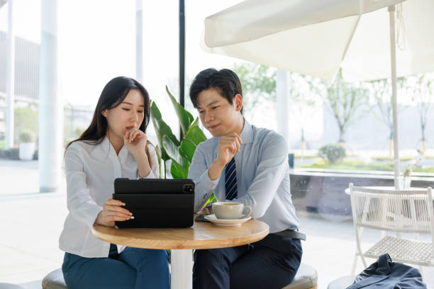 istock Young businessmen discuss work in coffee shops 1391010330