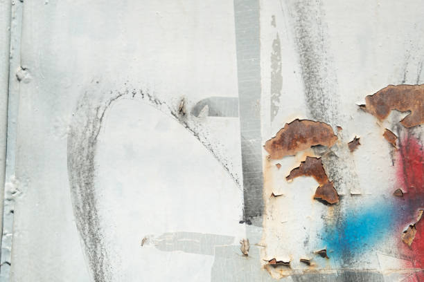 istock Rusty and paint stained metal background 1391011559
