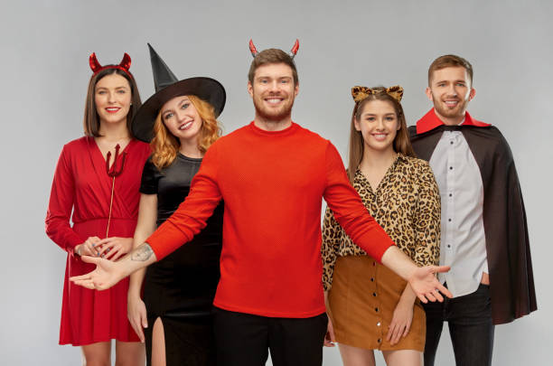 istock happy friends in halloween costumes over grey 1391012437