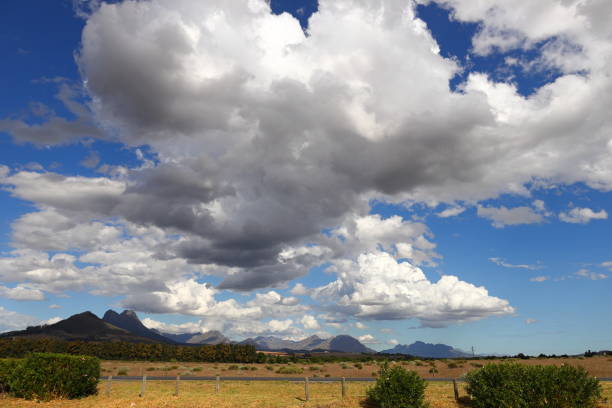 A panoramic view from the N1 highway over grassy fields towards Somerset West, South Africa.