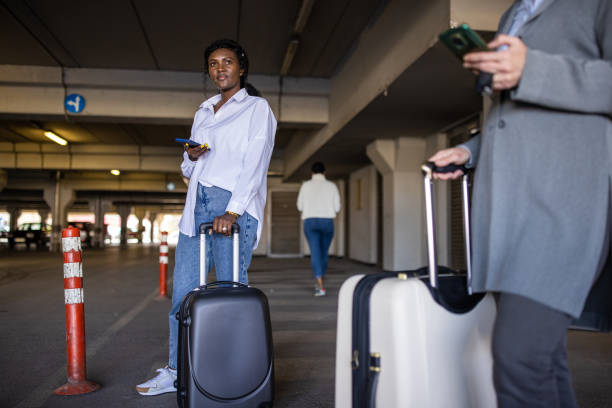 istock Multiracial women using phone while waiting for their transportation at the underground parking lot 1391015144
