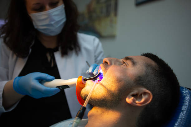 istock Close up of ultraviolet light procedure at dentist's office 1391015298