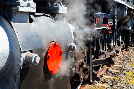 Old steam train blowing smoke on a journey