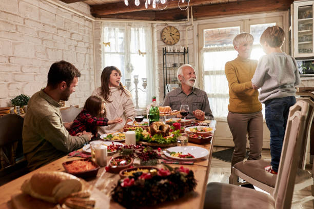 istock Happy extended family having lunch in dining room. 1391016830