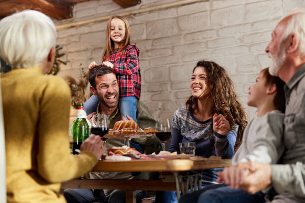 istock Happy extended family talking during lunch in dining room. 1391016966