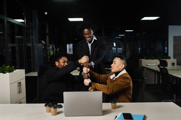 istock African and Asian colleagues making hand stack of fists. Multiethnical diverse teamwork online with laptop. Community spirit and friendship. Keeping high motivation. 1391023304