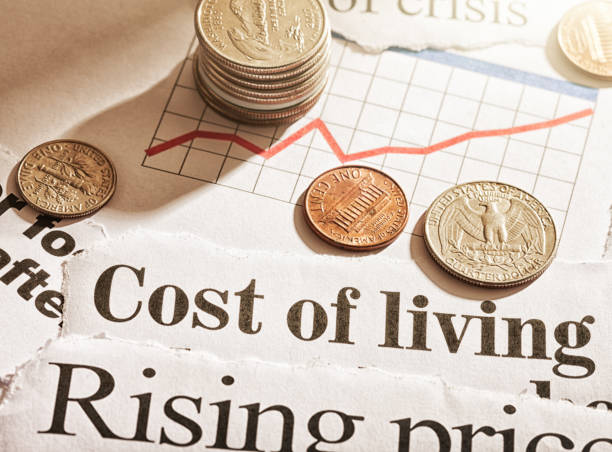 Inflation hits consumers: newspaper headlines about rising prices with US coins and rising graph stock photo