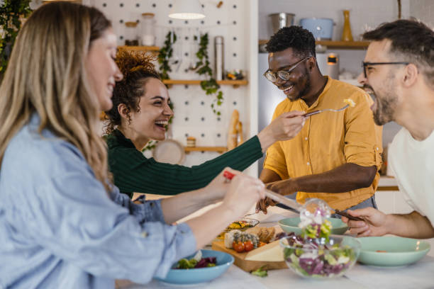 istock Friends eating together at home 1391026678