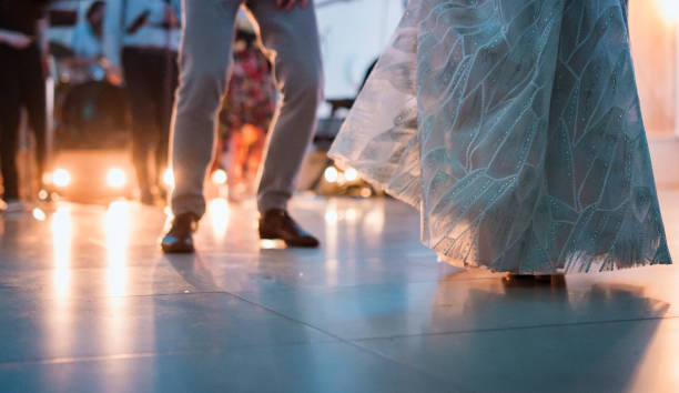 Unrecognizable female and male legs dancing at wedding.