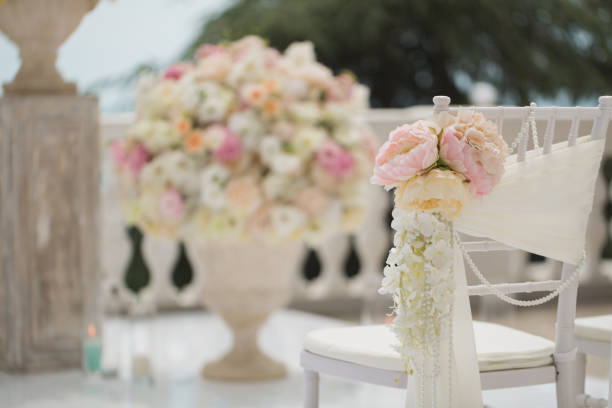istock wedding decorations flowers on chairs. Wedding exit registration, white chairs decorated for wedding. wedding setup detail 1391026931