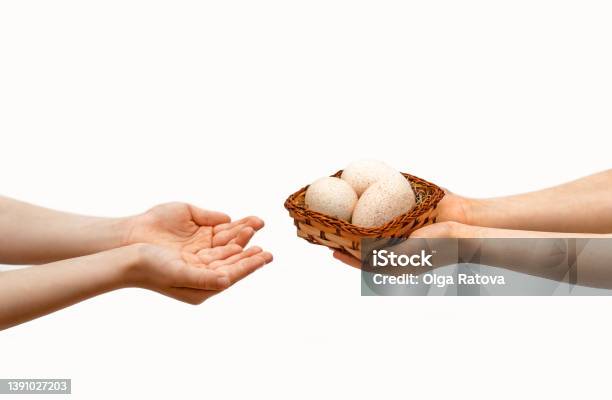 Easter Holiday The Childs Hands Pass A Basket With Easter Eggs To Another Child Stock Photo - Download Image Now