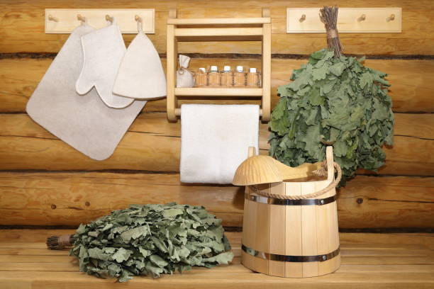 traditional sauna accessories and oak brooms in bath house. - wooden hub imagens e fotografias de stock