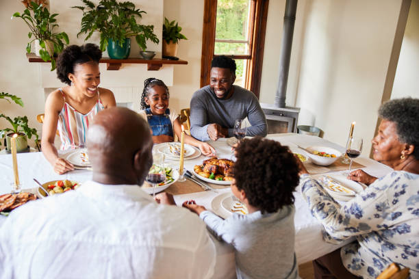 istock Smiling multi-generation family enjoying dinner together at home 1391028099