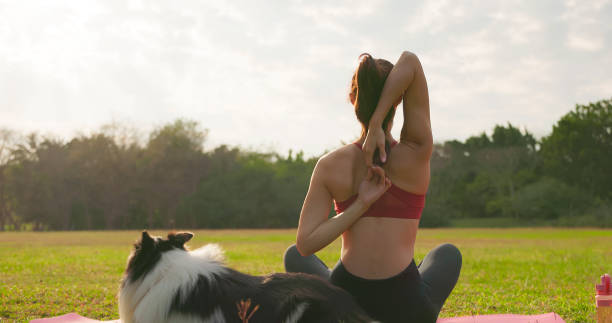 istock girl practice yoga with dog 1391028154