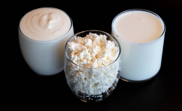 milk, cottage, soure cream in the glasses on the black background stock photo