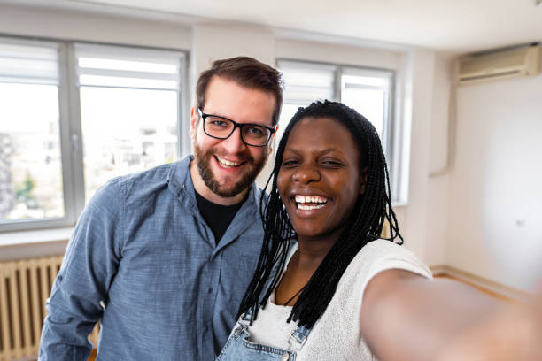 istock Newlyweds taking selfies in their new apartment 1391030727
