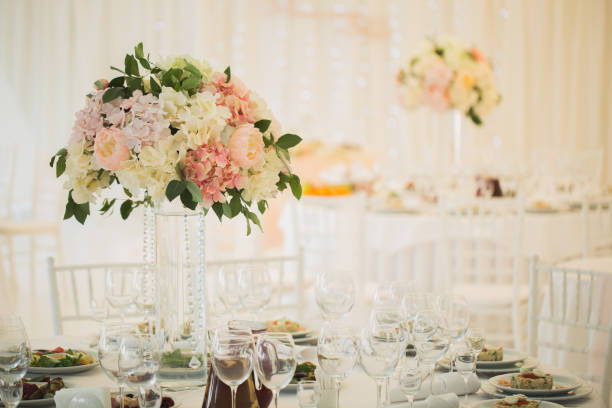 istock Vases with flowers on the wedding table 1391031976
