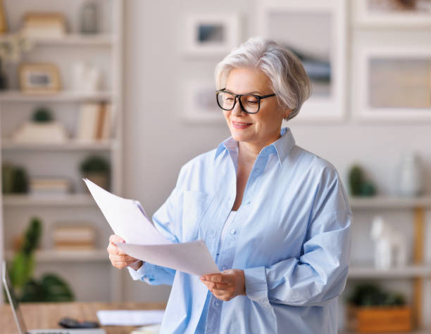 istock Mature businesswoman reading documents in home office 1391032711