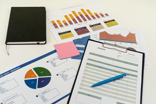 financial charts and graphs on desk. Businessman analyzing investment concept