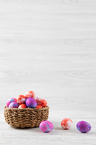 Easter eggs on white rustic background with copy space