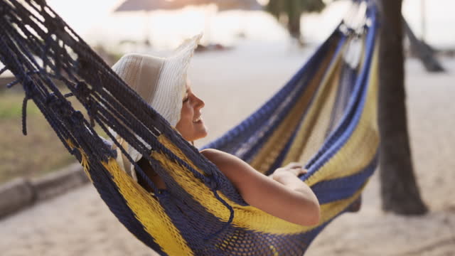 Woman in hammock on the beach