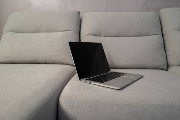 istock A laptop on a gray sofa in a modern and simple style 1391035888