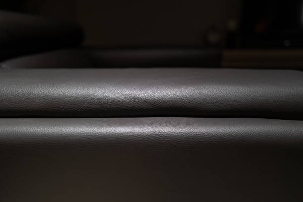 Partial close-up of dark gray sofa and floor in the room