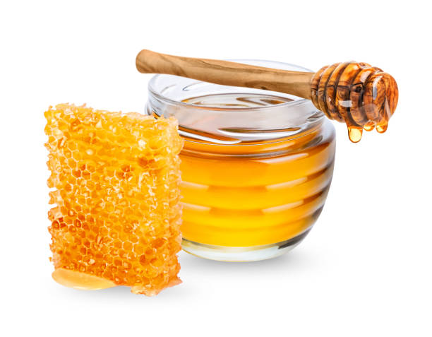 istock Jar with honey, honeycmb and honey dipper on white background 1391040899