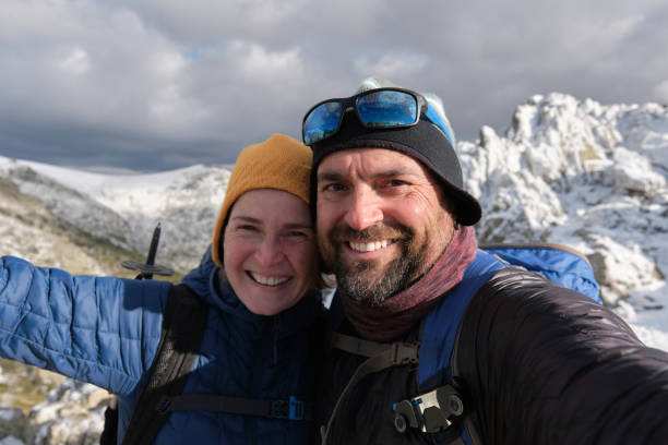 istock Satisfied tourist couple taking selfie in mountains 1391044111
