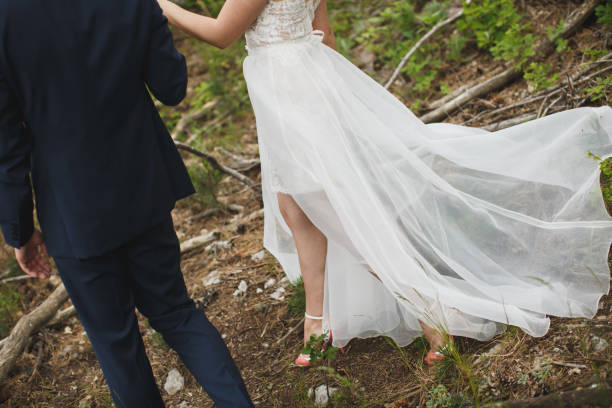 istock Bride and groom walking together holding their hands 1391044921