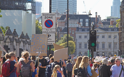 London, England - 09.20.2019:  People with posters. Parliament square, Westminster.