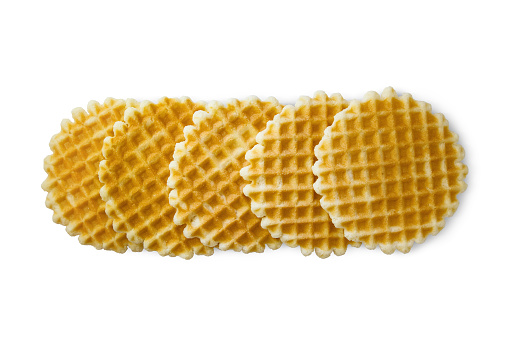 Round Belgian waffles isolated on white background, top view. Thin golden waffled cookie.