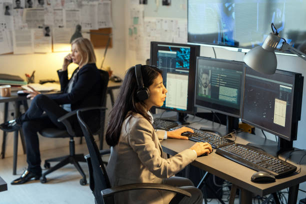 istock Serious agent of intelligence service sitting in front of computer monitors 1391048195