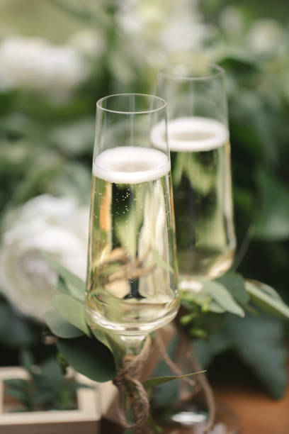 wedding glasses with champagne on the table. - champagne champagne flute wedding glass imagens e fotografias de stock